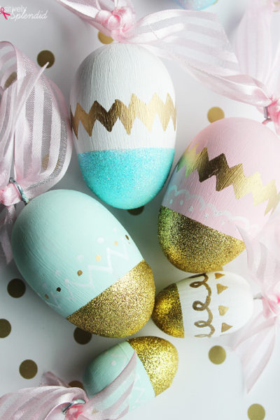 five wooden painted eggs with gold glitter