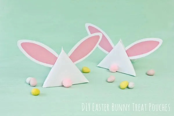 two paper bunny pouches filled with chocolate eggs