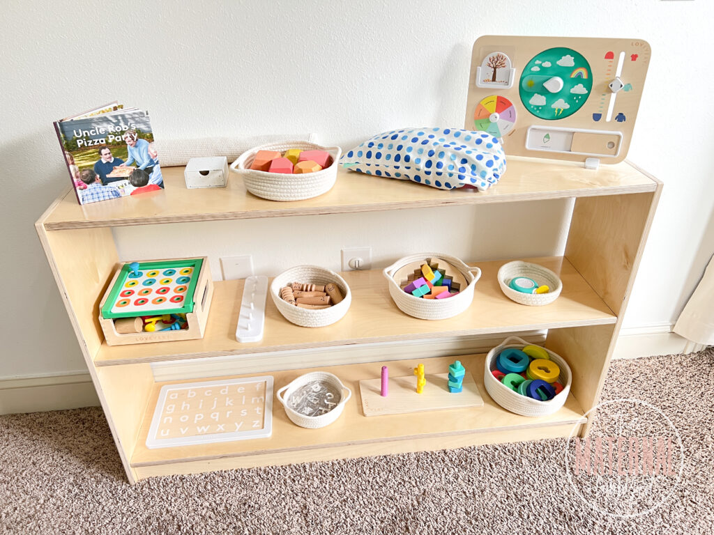Tall Montessori birch shelf filled with Lovevery Montessori toys ready to play with.