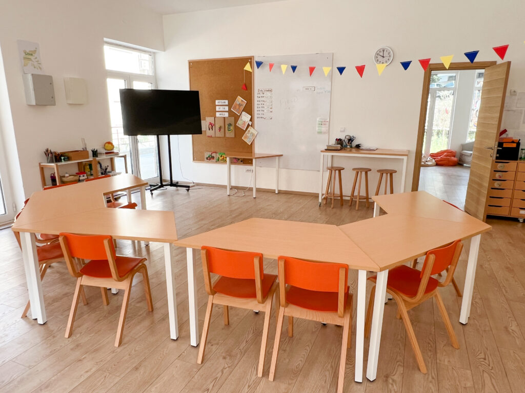 Pathfinders ages 9 to 12 classroom area with desks and chairs facing a whiteboard